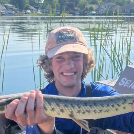 Graduate student John Lawrence displays a gar.